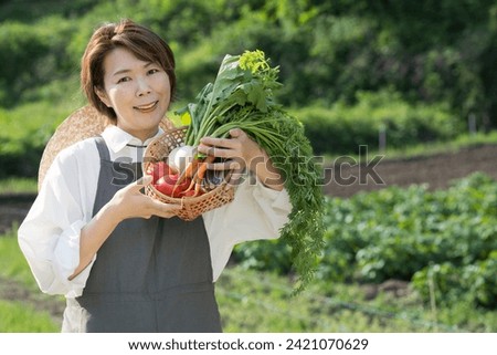 Image of a farm woman growing vegetables Close-up　looking at a camera	