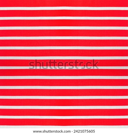 Seamless texture photo of red colored white and red striped cotton material.