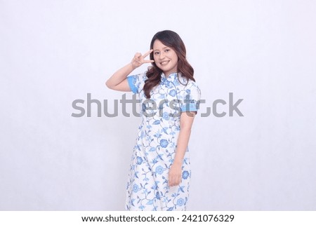Beautiful smile asian woman wearing modern chinese dress hand signed 2 two isolated on white background. happy Chinese New Year