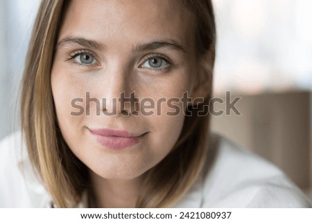 Close up cropped shot of beautiful young woman, smiling, staring at camera. Portrait of gorgeous millennial generation female with attractive appearance and perfect skin. Cosmetology, natural beauty Royalty-Free Stock Photo #2421080937