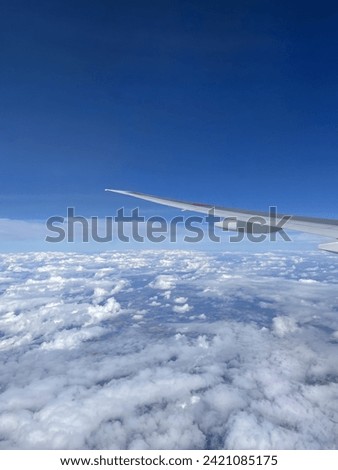 Sunny daytime wing view from ANA boeing 777-300ER Royalty-Free Stock Photo #2421085175