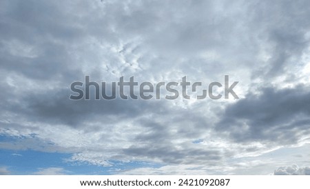 overcast clouds view from below. Grey sky foreshadows rain. the sun was covered by grey clouds. Royalty-Free Stock Photo #2421092087