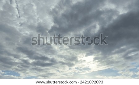 overcast clouds view from below. Grey sky foreshadows rain. the sun was covered by grey clouds. Royalty-Free Stock Photo #2421092093
