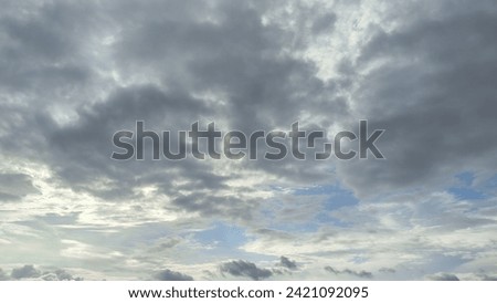 overcast clouds view from below. Grey sky foreshadows rain. the sun was covered by grey clouds. Royalty-Free Stock Photo #2421092095