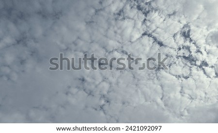 overcast clouds view from below. Grey sky foreshadows rain. the sun was covered by grey clouds. Royalty-Free Stock Photo #2421092097