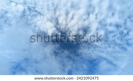 overcast clouds view from below. Grey sky foreshadows rain. the sun was covered by grey clouds. Royalty-Free Stock Photo #2421092475