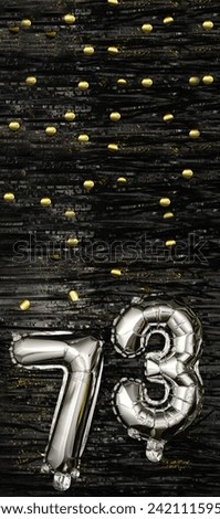 Greeting celebration seventy-three years birthday. Anniversary number 73 foil silver balloon on black background. Happy birthday, congratulations concept. golden confetti. Vertical banner