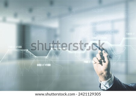 Multi exposure of businessman hand with pen working with creative statistics data hologram on blurred office background, stats and analytics concept