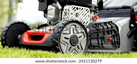 lawn mower on a flat green lawn. High quality photo