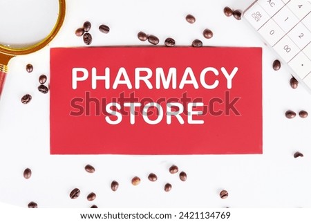 PHARMACY STORE writing on a red card on a white background with coffee beans and a magnifying glass
