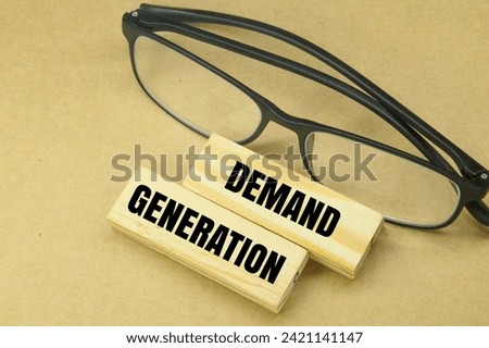 glasses and stick with the word Demand Generation Royalty-Free Stock Photo #2421141147
