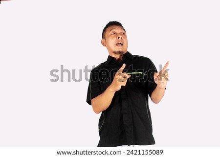 Asian adult man showing happy expression while pointing up
