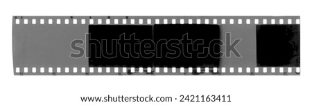 Strip of old exposed celluloid film isolated on background Royalty-Free Stock Photo #2421163411