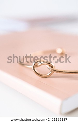 Gold wedding rings on a book on a white background. Selective focus.