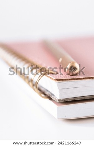 Notebook and pen on white background - soft focus with vintage film filter