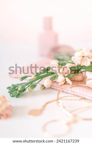 gold jewelry and flower on white background - soft focus with vintage film filter