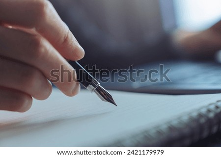 Businessman signing financial contract and hand holding pen putting signature after reaching an agreement.