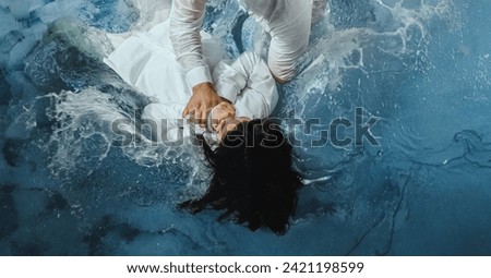 A Protestant pastor baptizes a man in water in the name of Jesus Christ Royalty-Free Stock Photo #2421198599