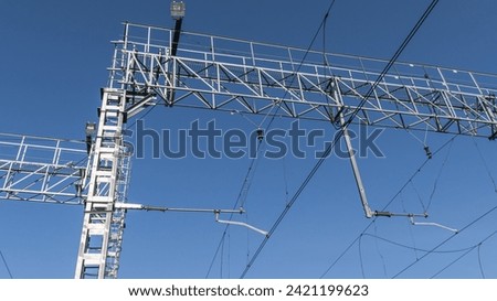Electric contact line for the movement of electric locomotives. Equipment for the movement of electric locomotives. Wires for the power supply of electric locomotives on the railway. Royalty-Free Stock Photo #2421199623