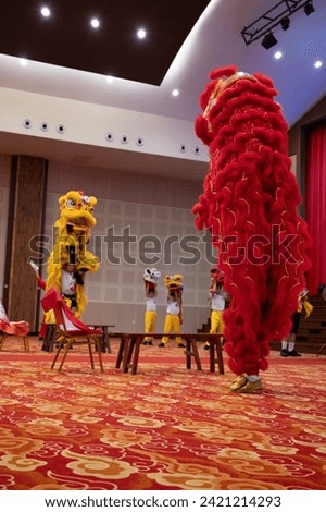 A traditional Chinese dance "Lion Dance" being performed in a school auditorium