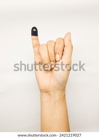 a hand with ink in Little finger or pinkie gesture hand sign on white background. meaning a sign of general election