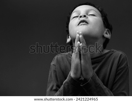 little boy praying to God with people stock image stock photo