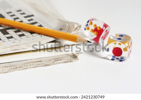 Newspaper, pencil and transparent dice on a white background Royalty-Free Stock Photo #2421230749