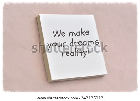 Text we make your dreams reality on the short note texture background