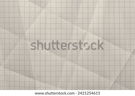 Close-up of graph ruled composition or exercise book paper with rough texture.
