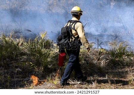 Forestry officer starts prescribed fire