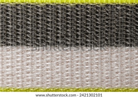 Close up texture of black and white with yellow borders nylon fabric band. Background for designers.