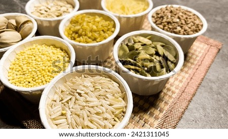 various cereals for a healthy diet, on the background of a stone table made of black marble Royalty-Free Stock Photo #2421311045