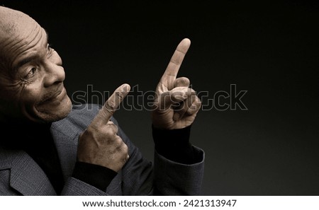 man pointing his finger with grey black background with people stock image stock photo