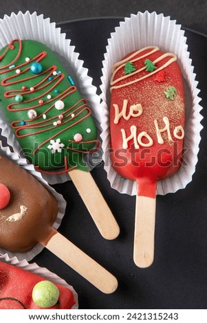 Christmas dessert. Sweet food. Cheesecake on a stick in the shape of ice cream. Children's treat in winter. Candy Christmas tree Ho Ho Ho. Gingerbread cookies.