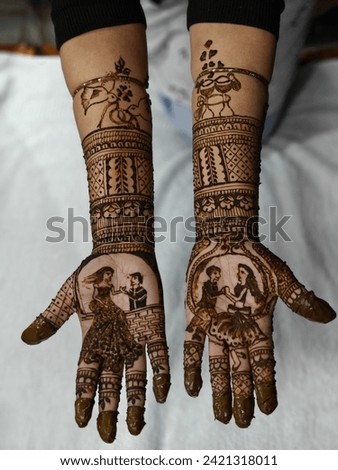 Indian Traditional Bridal Mehendi or Henna design on bride's hand. Groom and bride art shown in Henna Design. Royalty-Free Stock Photo #2421318011