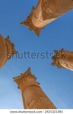 Vertical photo. View from below at columns of the Temple of Zeus against a blue sky. Ruins of Jerash.  Jordan.