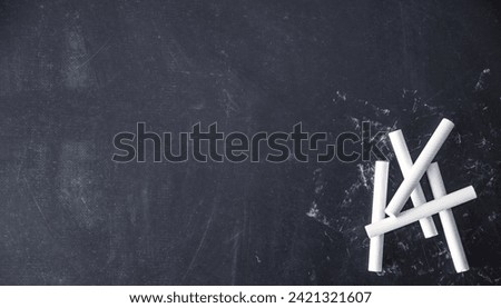 white chalks on black background Royalty-Free Stock Photo #2421321607
