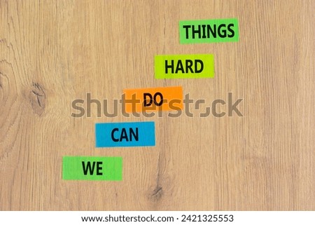 We can do hard things symbol. Concept words We can do hard things on colored paper. Beautiful wooden background. Business, we can do hard things concept. Copy space. Royalty-Free Stock Photo #2421325553