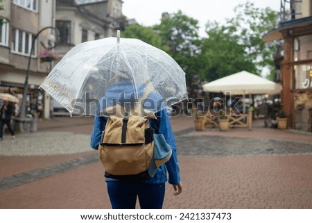  portrait of a girl walks in the autumn city under an umbrella. High quality photo