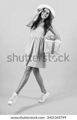 positive birthday woman hold present isolated on yellow. birthday woman hold present at studio