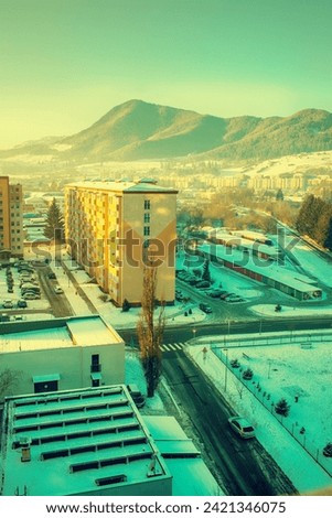 View of a town in winter season.Mountains in background. High quality photo