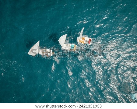Aerial View of Small Sailboats Racing on Sea Royalty-Free Stock Photo #2421351933