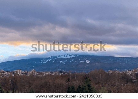 a mountain with a city in the background
