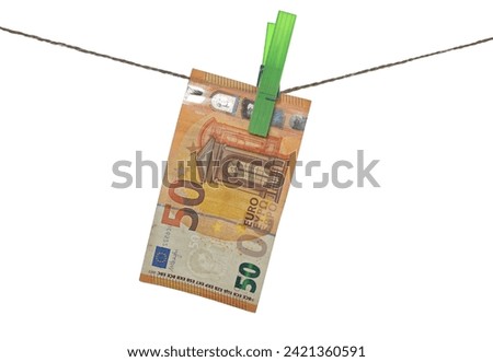 Fifty euro banknote is drying, banknote dry hanging on clothesline string with a clothespin, money laundering, isolated on white  
 Royalty-Free Stock Photo #2421360591