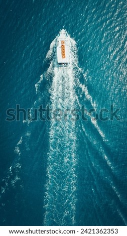 Cruise Ship Making Waves in Vast Blue Ocean Royalty-Free Stock Photo #2421362353