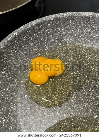 Quadruple yolk egg that is incredibly rare with a chance of one in eleven billion of being cracked Royalty-Free Stock Photo #2421367091