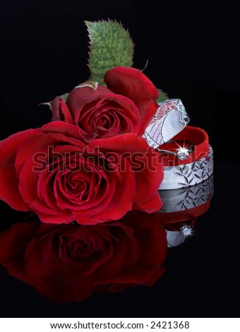 Valentine red roses and sparkling diamond ring in a gift box