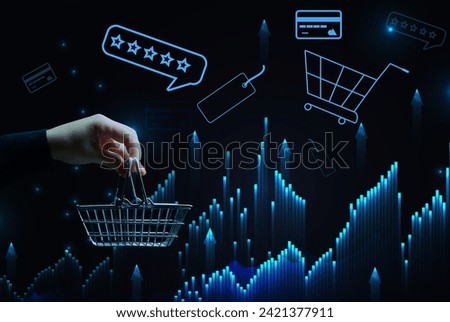 A woman's hand holds a metallic shopping cart and payment card icons, the concept of starting a sale, high income in retail business