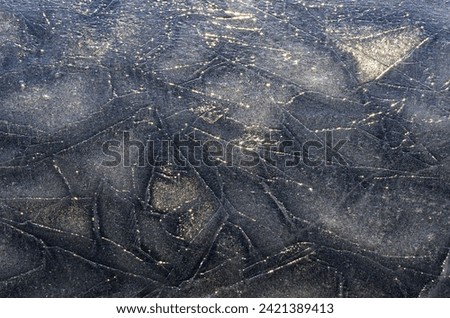 Sun rays on ice. Silver ice texture. Background photo.
