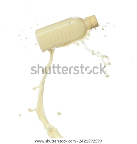 Tofu Soybean soymilk pour fall down in bottle container. Soybean milk or cosmetic cream moisturizer spill splash as paint color. White background isolated high speed shutter freeze motion